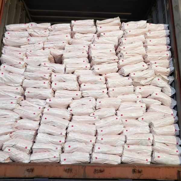 Pallet of Tide detergent buckets with a forklift in the warehouse.