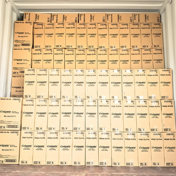 Container loaded with pallets of Colgate product boxes for wholesale shipment by Asia Grocery