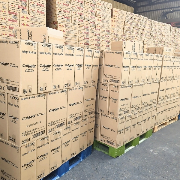 Stacks of Colgate product boxes in Asia Grocery's warehouse, ready for bulk wholesale orders