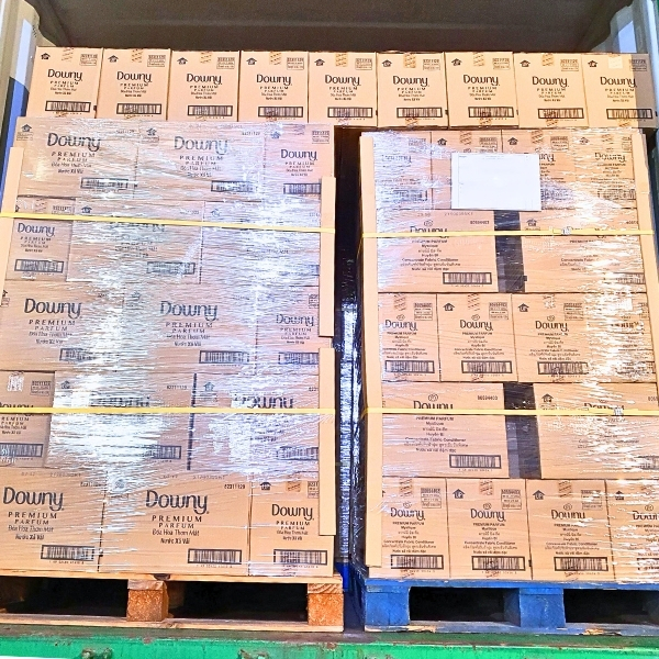 Pallet of Downy fabric softener boxes being loaded for shipment by Asia Grocery, ensuring global delivery