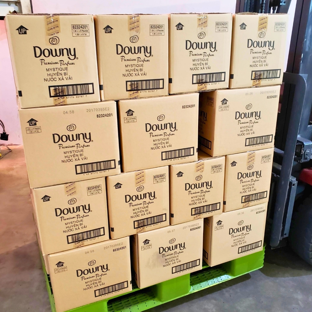 Pallets of Downy Mystique wholesale boxes stored in a warehouse.