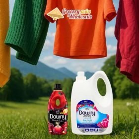 Downy products with vibrant fabrics in a natural setting, illustrating sustainability in fabric care.